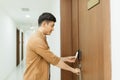 Asian man hand holding Access card / Key Card eletronic door accessing control scanning to lock and unlock door Royalty Free Stock Photo