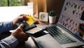 Asian man hand is pulling a credit card out of his pocket in order to complete online shopping on the computer Royalty Free Stock Photo