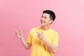 Asian a man handsome young pointing with two hands and fingers to the side on pink background