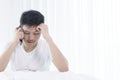 Asian man has wake up with talking about job before start working on bed in the morning. Royalty Free Stock Photo
