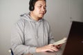 Asian man having video teleconference on his laptop at home online learning or working from home