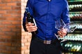 Asian man holding bottle of wine Royalty Free Stock Photo