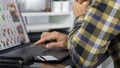 Asian man holding credit card and typing information on internet with laptop at home, online shopping concept Royalty Free Stock Photo