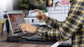 Asian man holding credit card and typing information on internet with laptop at home, online shopping concept Royalty Free Stock Photo