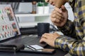 Asian man holding credit card and typing information on internet with laptop at home, online shopping concept Royalty Free Stock Photo