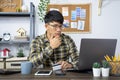 Asian man holding credit card and typing information on internet with laptop at home, online shopping concept Royalty Free Stock Photo