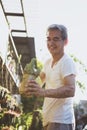 Asian man holding plant pot and toothy smiling with happiness face Royalty Free Stock Photo