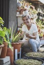 Asian man holding plant pot and toothy smiling with happiness face Royalty Free Stock Photo