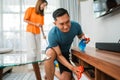 asian man holding rag wiping table Royalty Free Stock Photo