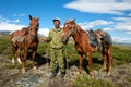 Asian man holding two horses Royalty Free Stock Photo