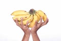 Asian man holding yellow ripe banana fruit speckled on white background with cutting path.