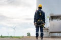 Asian man Inspection engineer preparing and progress check of a wind turbine with safety in wind farm in Thailand