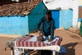 Asian man irons clothes by the coal iron outdoor