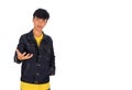 An Asian man in jeans jacket intoducing something by hand in his