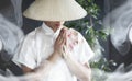 Asian man in a kimono prays with a book Royalty Free Stock Photo