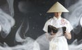 Asian man in a kimono prays with a book Royalty Free Stock Photo