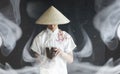 Asian man in a kimono prays with a book Royalty Free Stock Photo