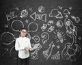 Asian man with laptop and blackboard startup sketch Royalty Free Stock Photo