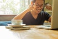 Asian man with laptop raised hands up celebrate success in great news. Royalty Free Stock Photo