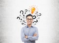 Asian man, light bulb and question marks Royalty Free Stock Photo
