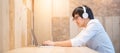 Asian man listening to music using laptop computer Royalty Free Stock Photo