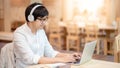 Asian man listening to music using laptop computer Royalty Free Stock Photo