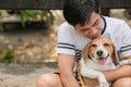 Asian man lovely cute playing with his puppy animal pet , Beagle are friendly dog with human Royalty Free Stock Photo