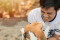 Asian man lovely cute playing with his puppy animal pet , Beagle are friendly dog with human Royalty Free Stock Photo