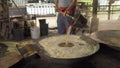 Asian man making boiled palm coconut sugar or cane production process, raw material, Amphawa, Thailand. Traditional culture