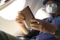 Asian man male air traveler reading ebook on flight