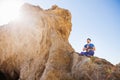 Asian man meditates in yoga position on high Royalty Free Stock Photo