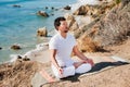 Asian man meditates in yoga position on high Royalty Free Stock Photo