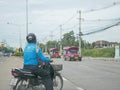 Asian man on a motorbike is making a hasty decision to make a U-turn in traffic