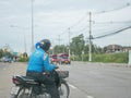 Asian man on a motorbike is making a hasty decision to make a U-turn in traffic