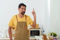 Asian man with mustaches Dressed in an apron overalls, held up forefinger, which was fanned with bandaged bandage. After injuring