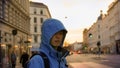 Asian man with outdoor jacket with sunset European architecture