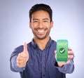 Asian man, phone and thumbs up in payment received ecommerce, transaction or internet banking success. Portrait of happy