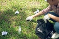 Asian man picking up plastic household waste in park Royalty Free Stock Photo