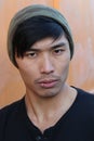 Asian man with piercing and beanie