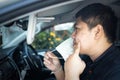 Asian man with pimple on skin,look at inflamed acne spot in front of a mirror,male pointing at acne on cheeks under face mask,skin