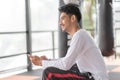 Asian men are playing mobile phones in the gym Royalty Free Stock Photo