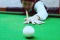 Asian man playing snooker aiming his cue Royalty Free Stock Photo