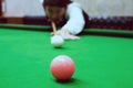 Asian man playing snooker aiming his cue Royalty Free Stock Photo