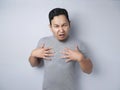 Asian Man Pointing Himself with Unhappy Expression as if he confused to be accused Royalty Free Stock Photo