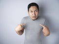 Asian Man Pointing Himself with Unhappy Expression as if he confused to be accused Royalty Free Stock Photo