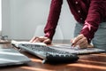 Asian man programmer holding pen to writing code data on document in clipboard while working to recheck code