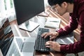 Asian man programmer looking on screen laptop to typing code data with keyboard about website and applications