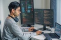 Asian man prompt engineer develop coding app with software data sitting in front of computer monitor at office Royalty Free Stock Photo