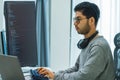 Asian man prompt engineer develop coding app with software data sitting in front of computer monitor at office Royalty Free Stock Photo