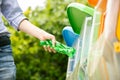 Asian man put plastic bottle into bin. Royalty Free Stock Photo